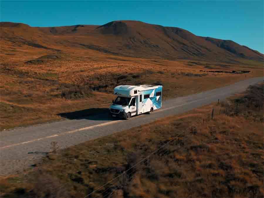 Motorhome on road between mountains
